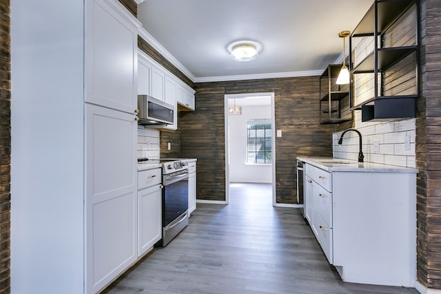 kitchen with white cabinetry, sink, crown molding, and appliances with stainless steel finishes