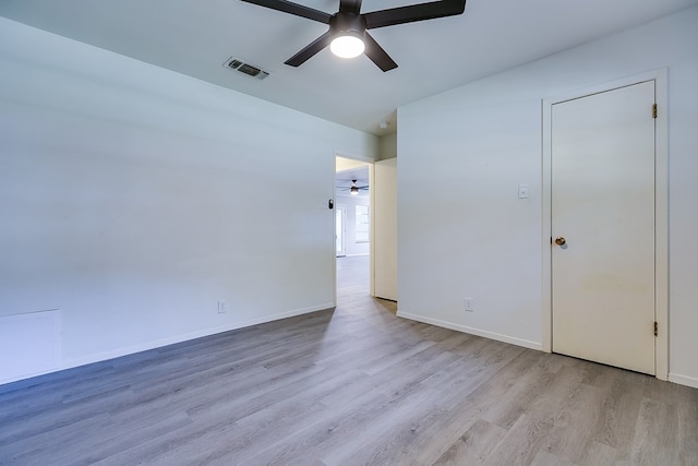 spare room featuring ceiling fan and light hardwood / wood-style floors