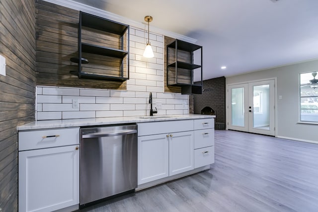 kitchen with french doors, sink, white cabinetry, dishwasher, and pendant lighting