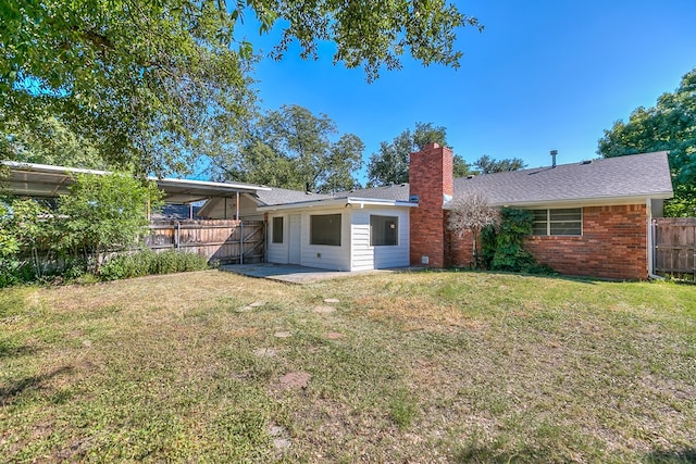 back of house with a yard and a patio area