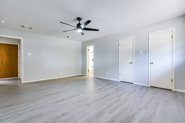 interior space with multiple closets, ceiling fan, and light wood-type flooring