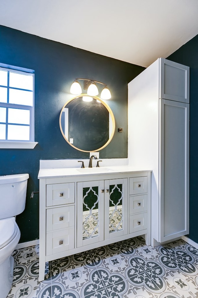 bathroom featuring vanity, tile patterned floors, and toilet