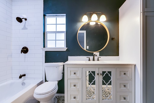 full bathroom featuring vanity, tiled shower / bath, and toilet