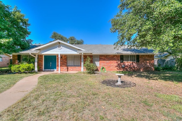 single story home with a porch and a front lawn