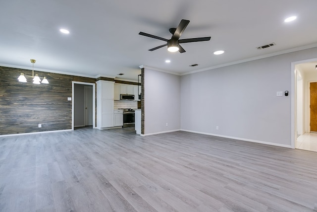 unfurnished living room featuring crown molding, ceiling fan with notable chandelier, and light hardwood / wood-style flooring