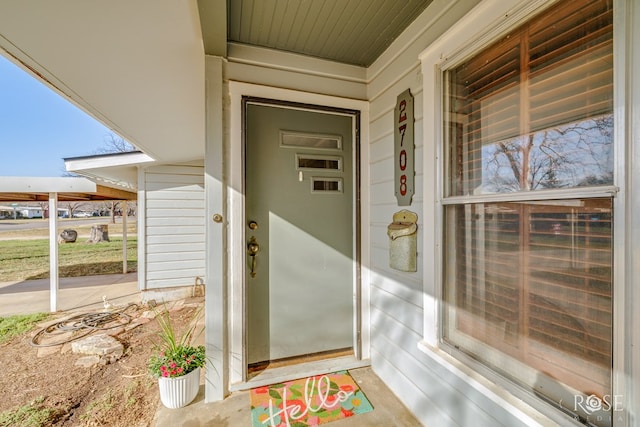 view of exterior entry with a porch