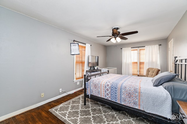 bedroom with ceiling fan, baseboards, and wood finished floors