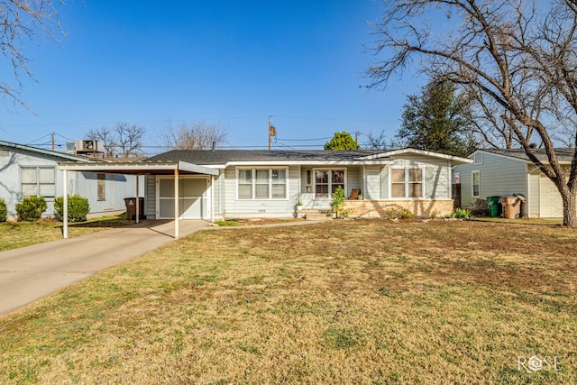 ranch-style home featuring a garage, concrete driveway, and a front yard