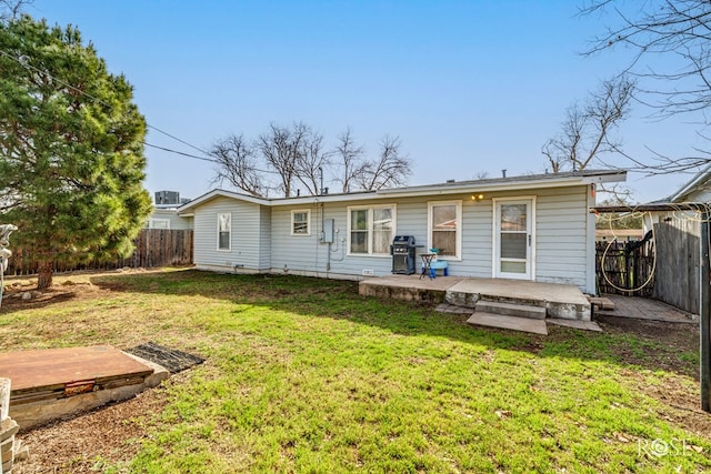 rear view of house with a patio area, fence, and a lawn