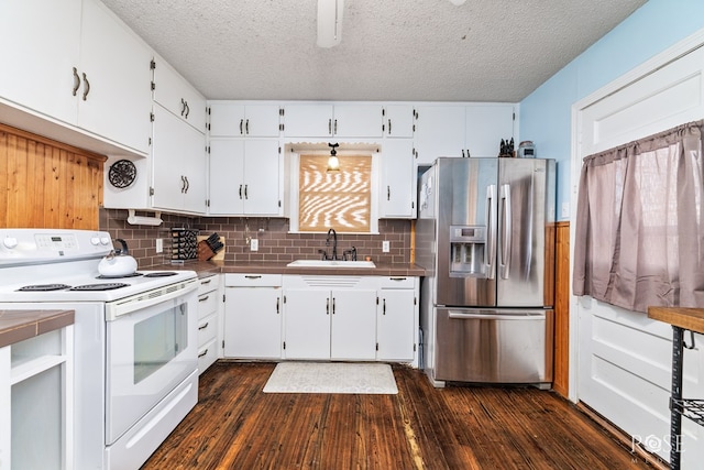 kitchen featuring white electric stove, dark wood-style floors, white cabinetry, stainless steel refrigerator with ice dispenser, and a sink