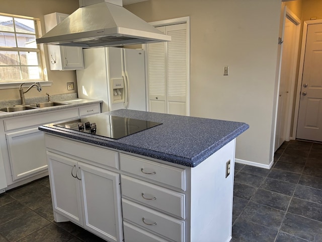 kitchen with sink, a kitchen island, island exhaust hood, white refrigerator with ice dispenser, and white cabinets