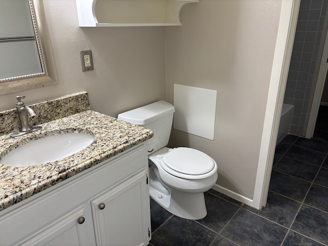 bathroom featuring vanity, toilet, and tile patterned flooring