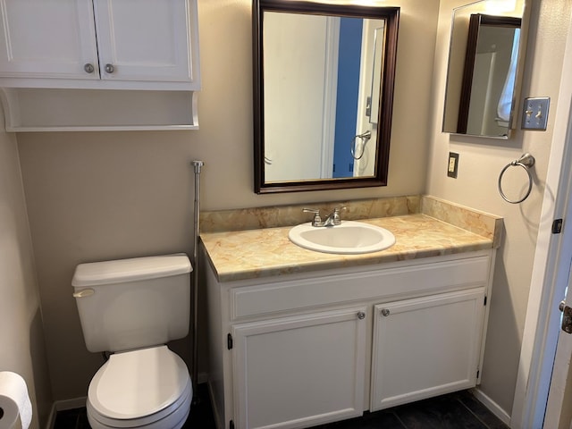 bathroom featuring vanity and toilet