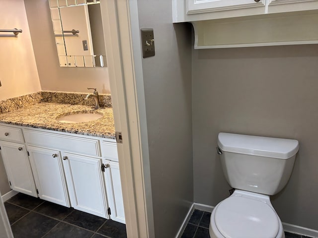 bathroom with tile patterned flooring, vanity, and toilet