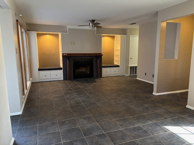 unfurnished living room with ceiling fan