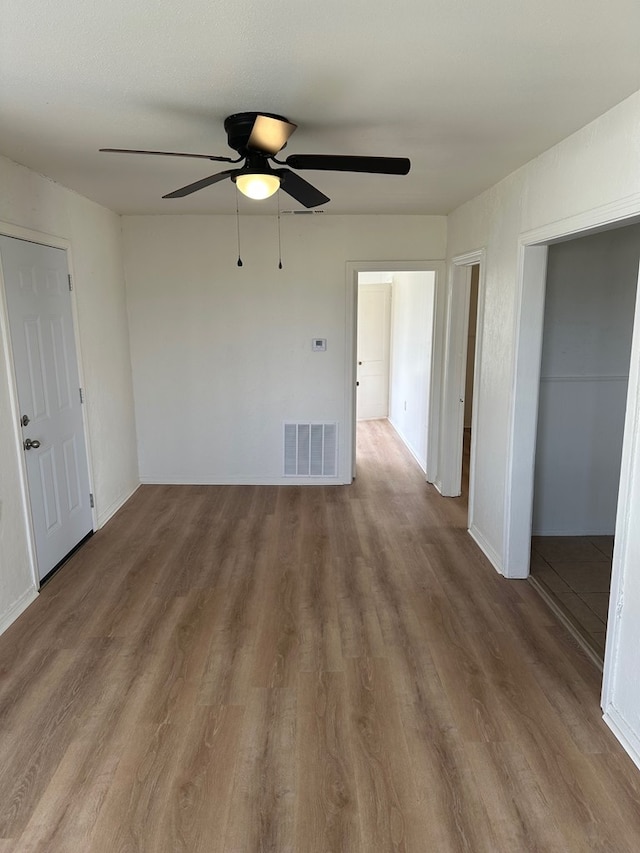 empty room with hardwood / wood-style flooring