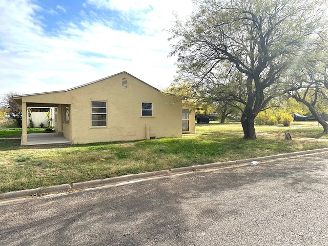 view of property exterior with a yard