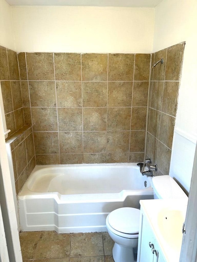 full bathroom with vanity, tiled shower / bath combo, and toilet