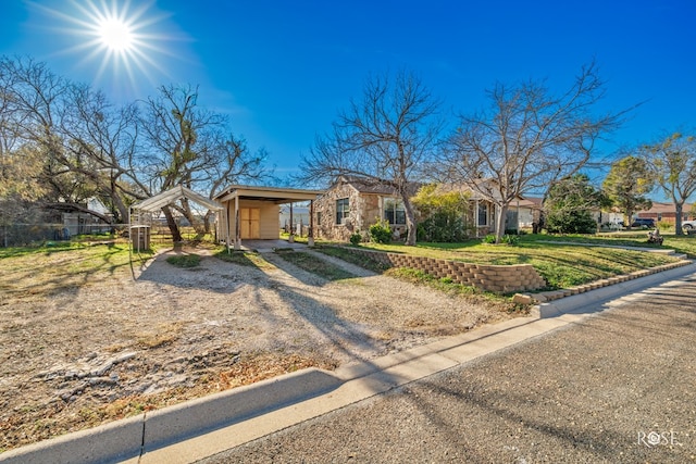 ranch-style home with a carport and a front lawn