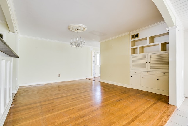 interior space featuring ornamental molding, visible vents, light wood-style floors, and an inviting chandelier