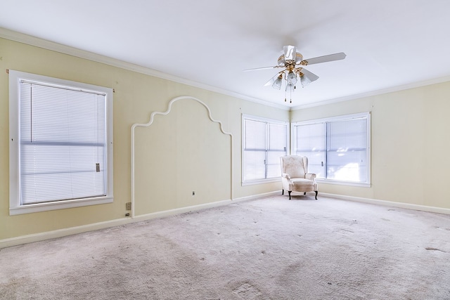 carpeted empty room with baseboards, ornamental molding, and ceiling fan