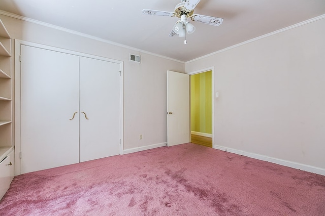 unfurnished bedroom featuring ornamental molding, carpet flooring, visible vents, and baseboards