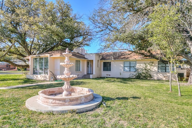 single story home with a front lawn and stucco siding