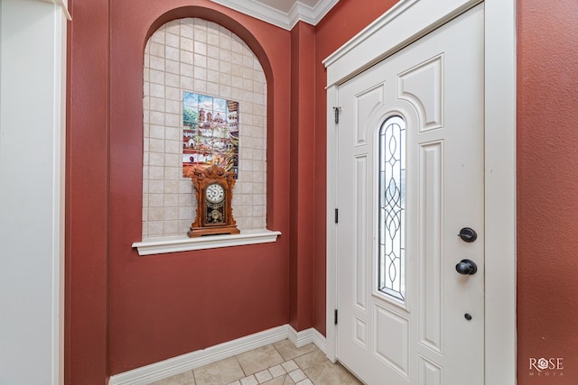 foyer entrance featuring crown molding and light tile patterned floors