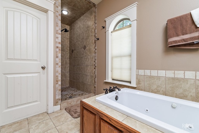 bathroom with shower with separate bathtub and tile patterned flooring