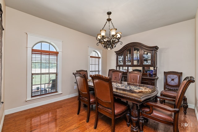 dining room featuring hardwood / wood-style flooring and an inviting chandelier