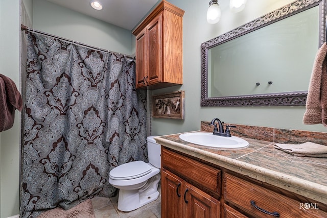 bathroom featuring vanity, curtained shower, and toilet