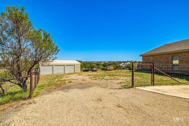 view of yard featuring an outbuilding and a garage