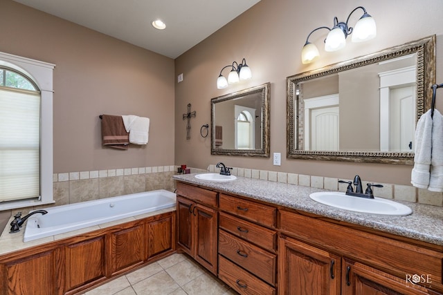 bathroom with tile patterned flooring, vanity, and a tub