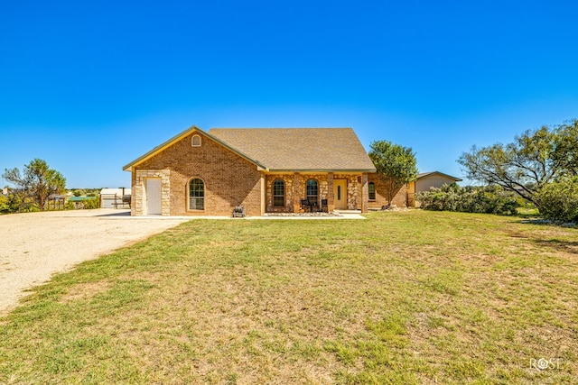 view of front of property with a garage and a front lawn