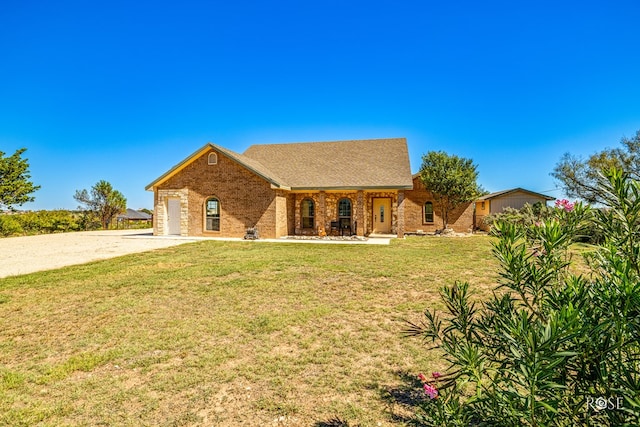 ranch-style house featuring a garage and a front yard