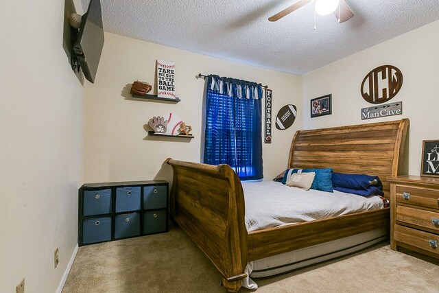 carpeted bedroom with a textured ceiling and ceiling fan