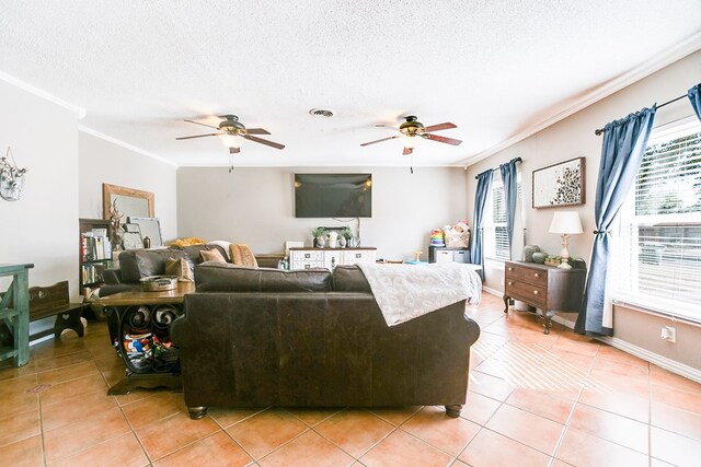 living room with tile patterned flooring, ceiling fan, crown molding, and a textured ceiling