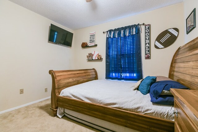 carpeted bedroom featuring a textured ceiling