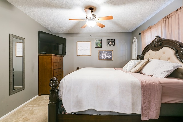 carpeted bedroom with a textured ceiling and ceiling fan