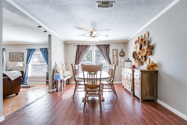 dining room featuring crown molding, plenty of natural light, dark hardwood / wood-style floors, and ceiling fan