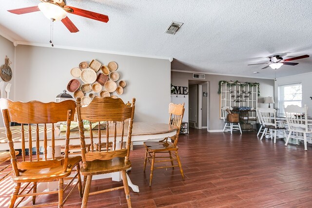 dining space featuring ceiling fan, ornamental molding, dark hardwood / wood-style flooring, and a textured ceiling