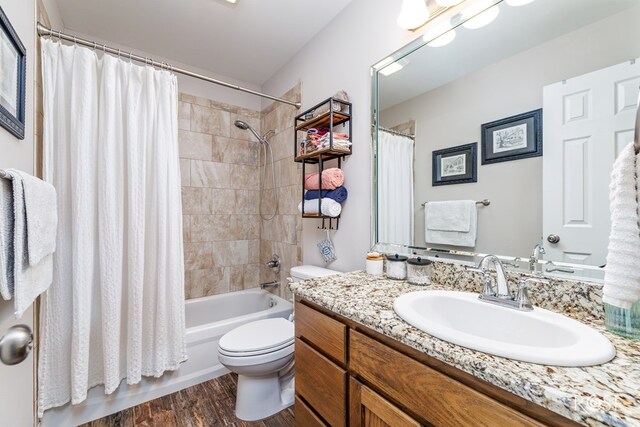 4137 Sedona Trl, San Angelo, TX 76904 - full bath featuring toilet, vanity, shower / bath combo with shower curtain, and wood finished floors