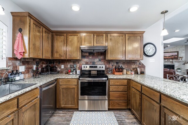 4137 Sedona Trl, San Angelo, TX 76904 - kitchen with stainless steel appliances, exhaust hood, dark wood-style floors, a sink, and backsplash