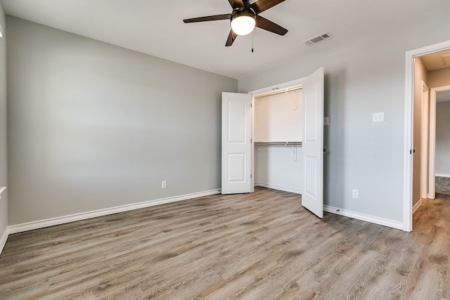 2822 Joshua St, San Angelo, TX 76905 - unfurnished bedroom featuring wood finished floors, baseboards, a closet, ceiling fan, and attic access