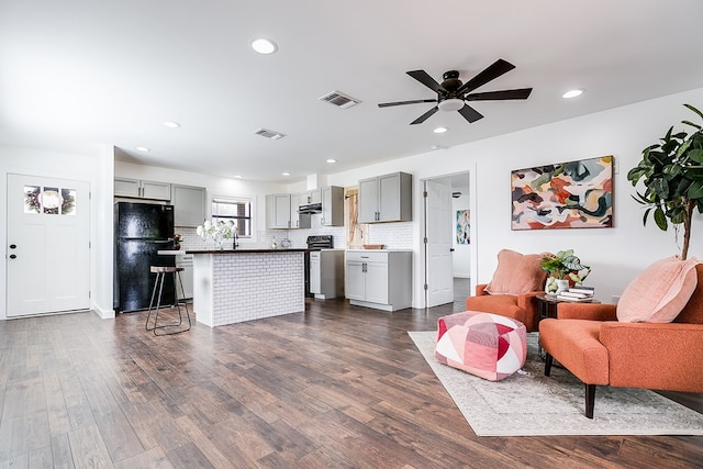 kitchen with visible vents, open floor plan, gray cabinets, and freestanding refrigerator