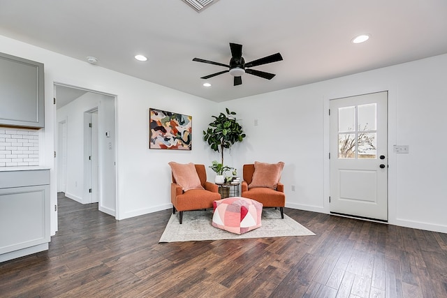 living area featuring dark wood-style floors, baseboards, and recessed lighting