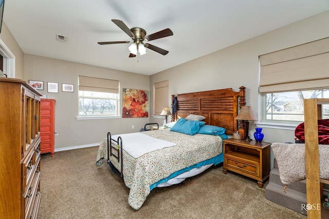 bedroom with ceiling fan and dark carpet