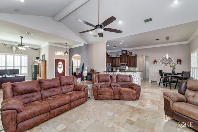 living room with ceiling fan, ornamental molding, and vaulted ceiling with beams