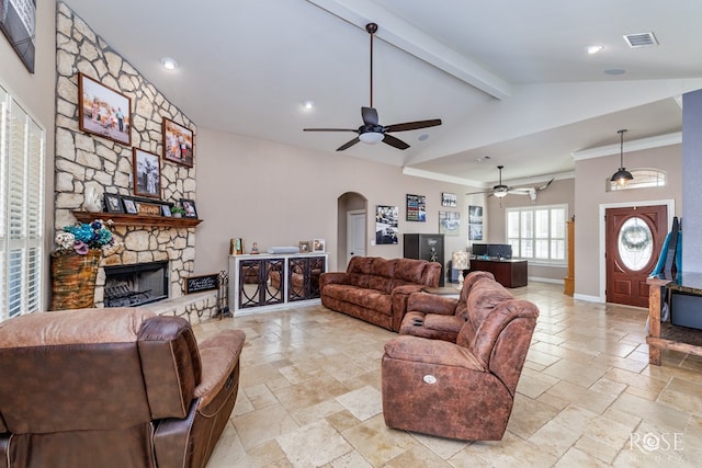 living room with ceiling fan, beam ceiling, high vaulted ceiling, a fireplace, and ornamental molding