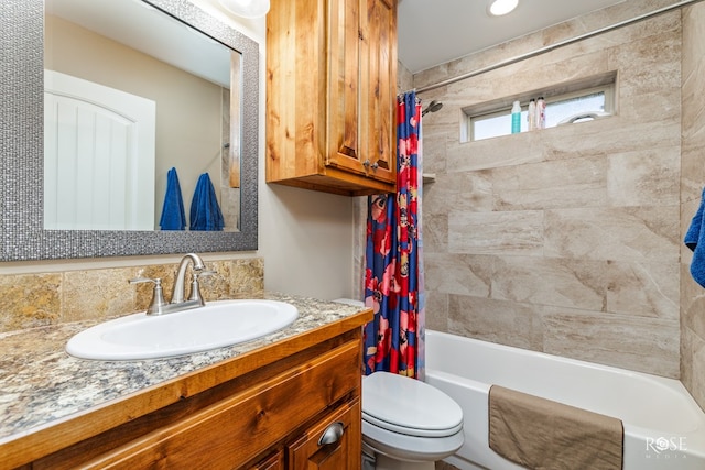 full bathroom featuring shower / tub combo, vanity, and toilet